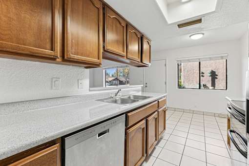 A kitchen with brown cabinets and white countertops.