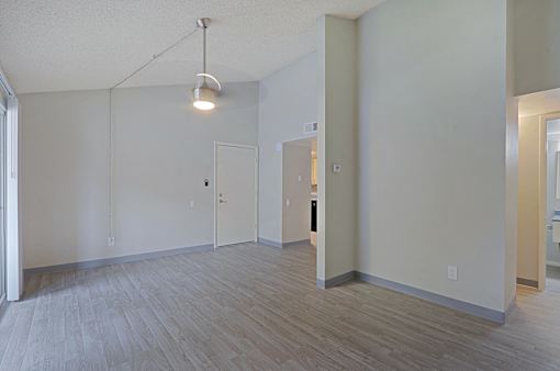 A room with a light hanging from the ceiling and a door on the right at Connect on Northern, Glendale, AZ 85301