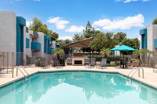A swimming pool in front of a modern building.