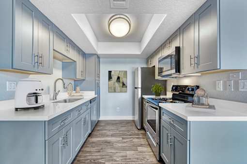 A kitchen with a white counter top and a sink at Tela Verde Apartment Homes, Glendale, 85306