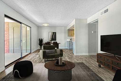 A modern living room with a black bean bag chair and a wooden coffee table at Tela Verde Apartment Homes, Glendale