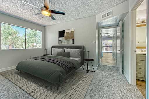 A bedroom with a bed and a ceiling fan at Tela Verde Apartment Homes, Glendale