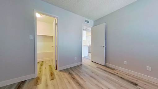 A room with a white door and a white wall.