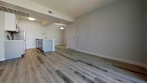 A room with a wooden floor and white walls.