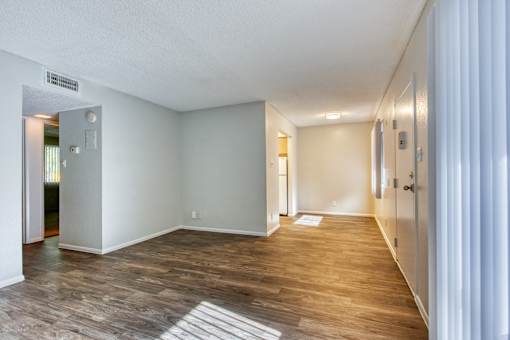 A room with wooden flooring and white walls. at The Link Apartments, Mesa, 85201