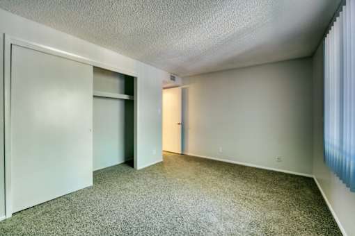 A room with a carpeted floor and two doors. at The Link Apartments, Arizona, 85201