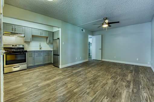 A kitchen with wooden floors and a ceiling fan. at The Link Apartments, Mesa, Arizona