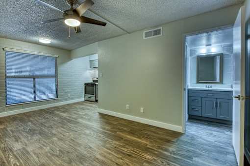 A room with a ceiling fan and wooden flooring. at The Link Apartments, Mesa, 85201
