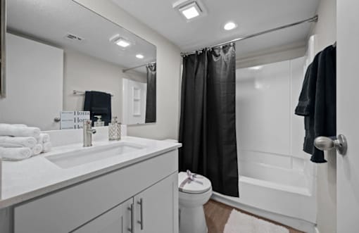 A bathroom with a white sink and a white toilet  at Tides on McDowell, Phoenix