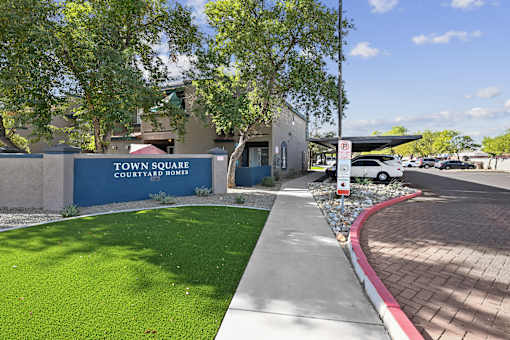 A sign that says "Town Square Courtyard Homes" is on a wall.