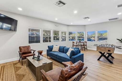 A living room with a blue couch and a coffee table.