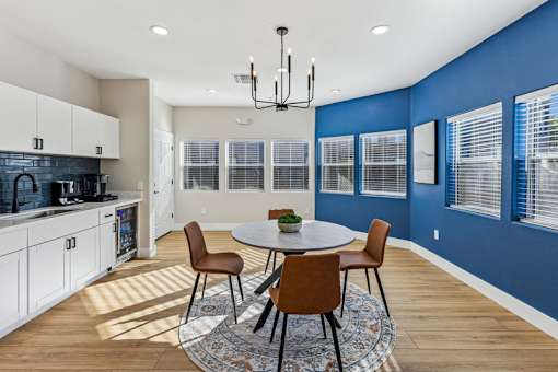 A dining room with a round table and chairs.