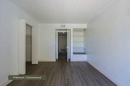A room with a wooden floor and white walls.
