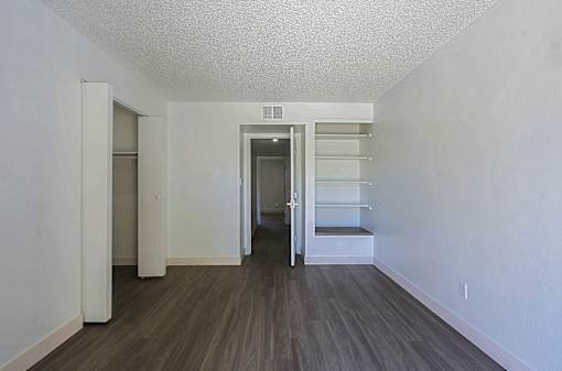 A room with a white ceiling and a wooden floor.