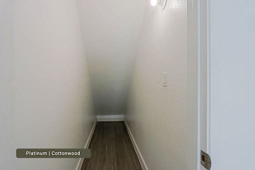 A hallway with platinum and cottonwood flooring.