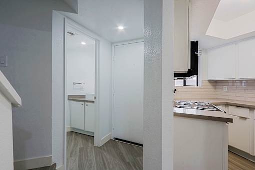 A kitchen with white cabinets and a countertop.