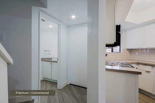 A kitchen with white cabinets and a countertop.