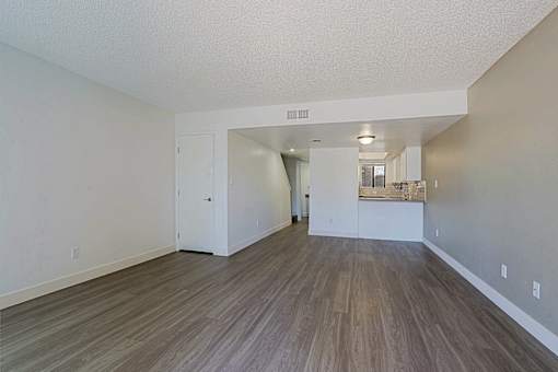 A room with a white door and a white wall.