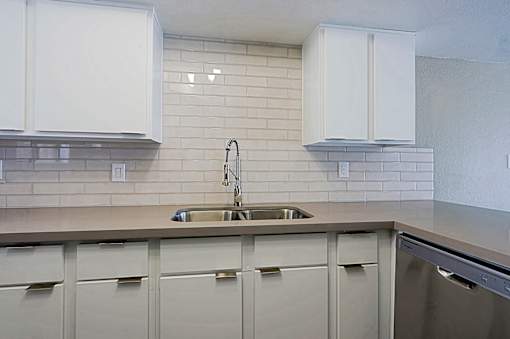 A kitchen with a sink and cabinets.
