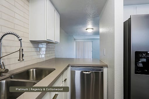 A kitchen with a stainless steel sink and dishwasher.