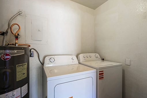 A washing machine and dryer in a small laundry room.