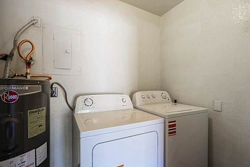 A washing machine and dryer in a small laundry room.