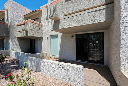 A building with a grey facade and a blue door.