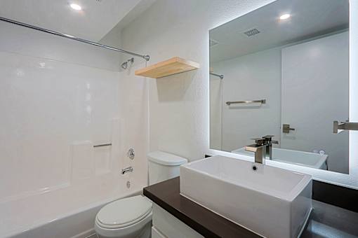 A white toilet sits next to a sink in a bathroom.
