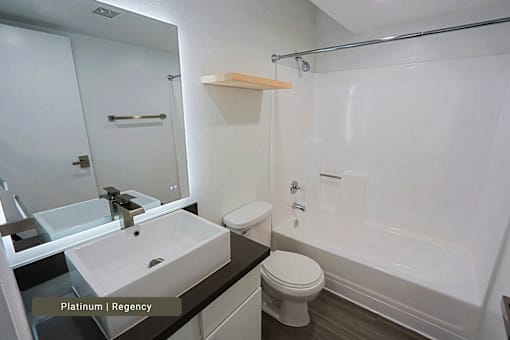 A bathroom with a sink, toilet, and bathtub.