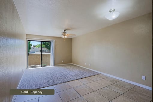 A room with a sliding glass door leading to a balcony.