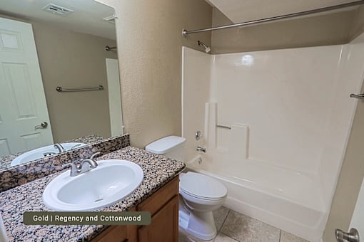 A bathroom with a sink, toilet, and bathtub.