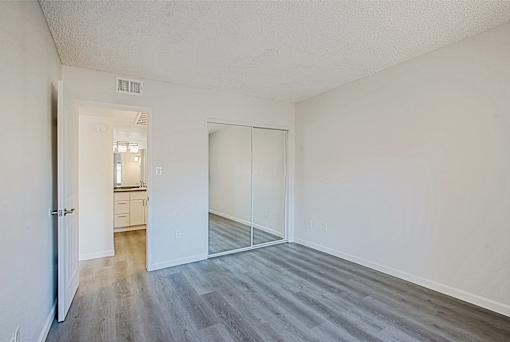 A room with a white door and a white wall.