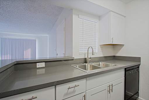 A kitchen with a sink and a stove.
