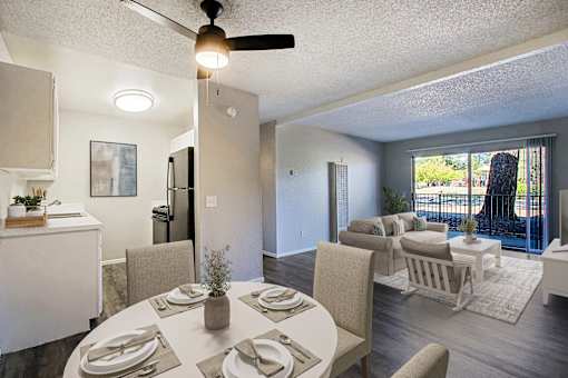 A dining room with a table set for a meal.