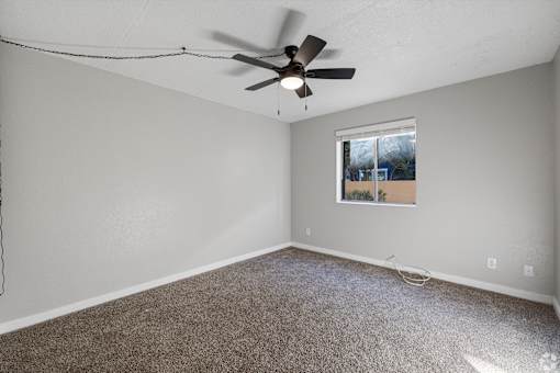 bedroom with a ceiling fan and a window