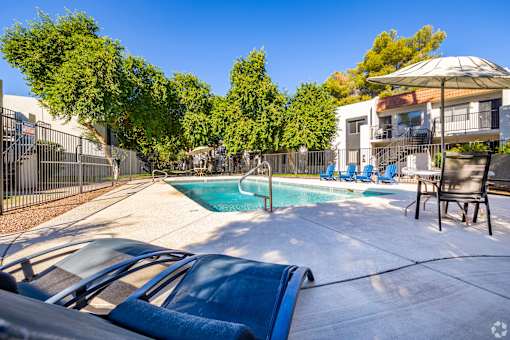 a swimming pool with chairs