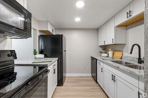 kitchen with appliances and white cabinets