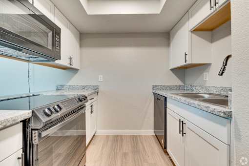 A kitchen with a stove top oven and a microwave.