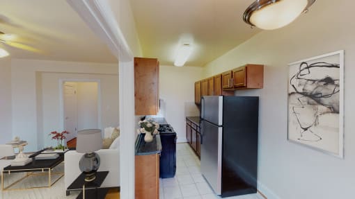 living area with sofa, coffee table and view of kitchen at the klingle apartments in washignton dc