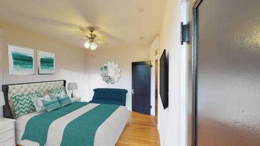 bedroom with bed, nightstand, hardwood floors, ceiling fan and large windows at the cortland apartments in washington dc