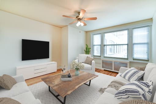 living area with sofa, coffee table, credenza, tv, hardwood floors and ceiling fan at  2701 Connecticut apartments in washington dc