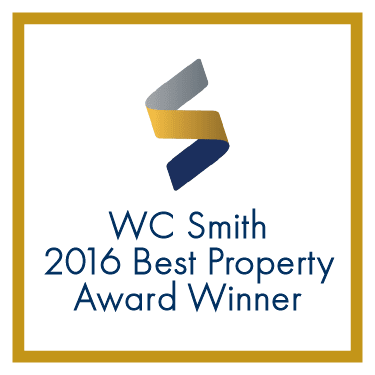 a yellow and blue logo with the words wc smith 2016 best property award winner