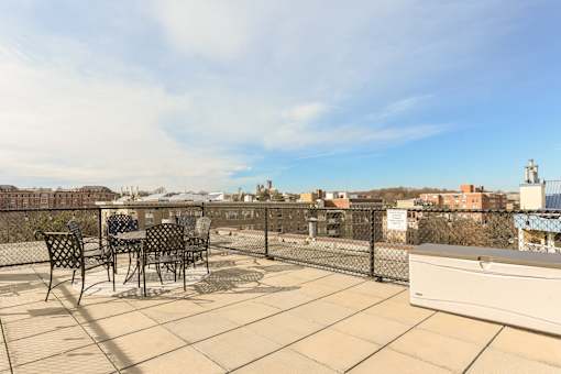 rooftop lounge with social seating and tables at 2701 connecticut  ave apartments in washington dc