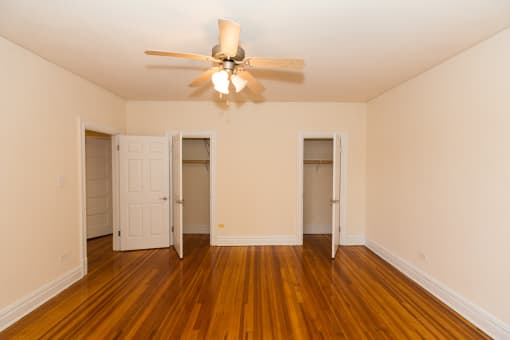 vacant bedroom with hardwood flooring and large closets at 2701 Connecticut apartments in washington dc
