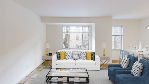 living area with sofa, coffee table and large windows at 2800 woodley apartments in washington dc