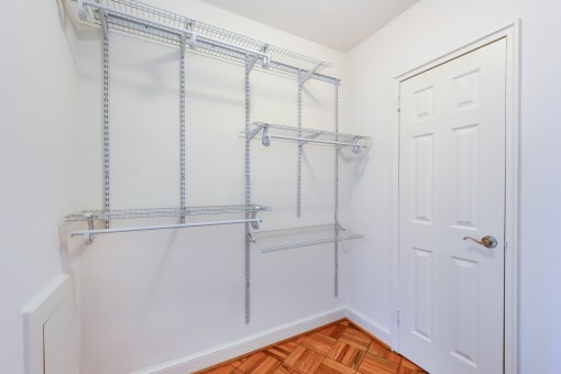 large closet with hardwood flooring and modern shelving at 2800 woodley road apartments in woodley park washington dc