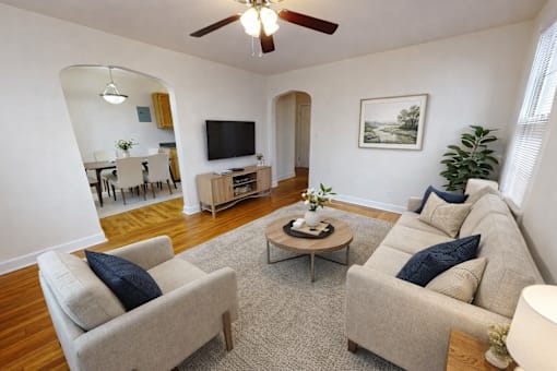 A living room with a beige couch, a coffee table, and a television.
