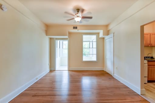 vacant living area with large windows, hard wood flooring and ceiling fan  at twin oaks apartments columbia heights washington dc