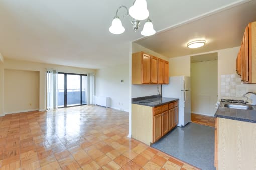kitchen with wood cabinetry, gas range and view of living area at twin oaks apartments columbia heights washington dc