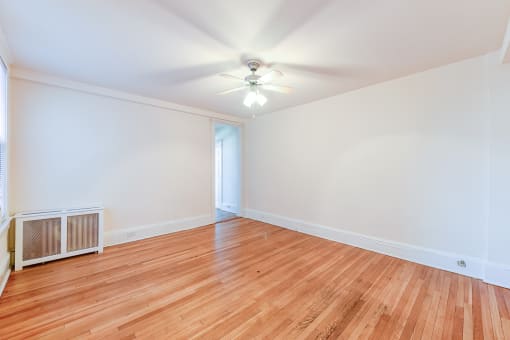 vacant living area with hardwood flooring and ceiling fan at the cortland apartments in washington dc